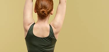 Womans toned back, illustrating the area targeted by upper, lower, and bra-line back lift surgery