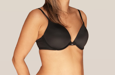 Side view of woman in Turkey after breast reduction surgery showing smaller, lifted, and natural-looking breast contour.