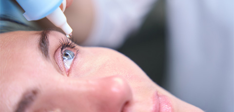 close up of patient receiving eye drops during examination for dry eye and floaters