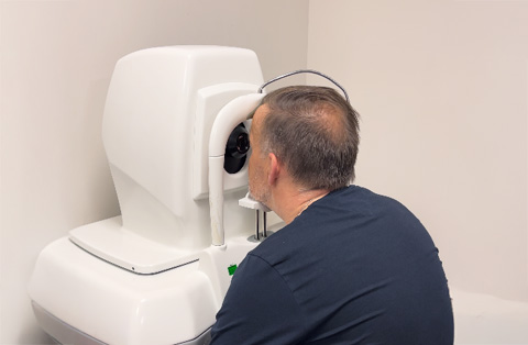 Male patient undergoing diagnostic eye scan as part of ophthalmology treatment