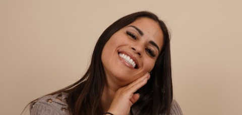 Woman touching jawline illustrating micrognathia or small jaw condition related to facial structure and treatment options