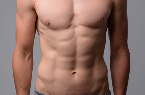 Toned male torso after six pack surgery in Turkey, showing defined abdominal muscles and sculpted physique