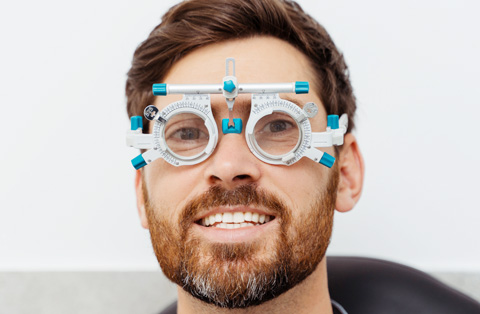 Man undergoing eye alignment test with trial frames before strabismus surgery in Turkey