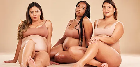 Three diverse women celebrating body confidence, representing the journey of a mommy makeover
