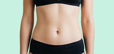 Female abdomen after tummy tuck surgery in Turkey, showing smooth, tightened skin and contoured waistline